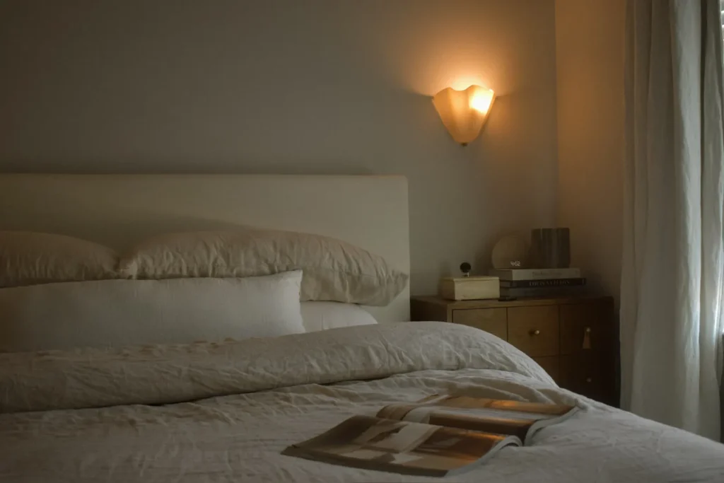 Bedroom with soft linens and wall sconce, Casa de Nubes, North Carolina