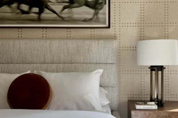 Bedroom with equestrian artwork and upholstered wall