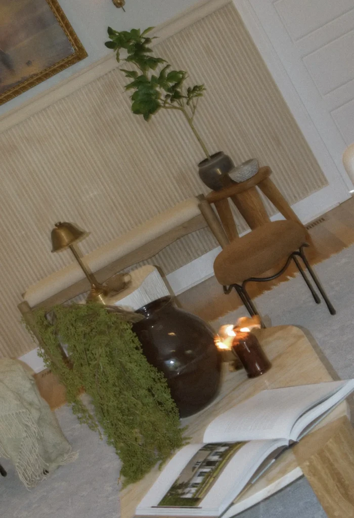The Curated Coastal Home, North Carolina: Travertine coffee table styled with books, greenery and candles