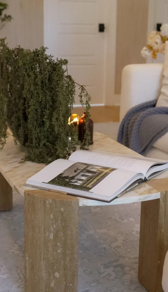 The Curated Coastal Home, North Carolina: Woven basket with throw blanket beside a blue upholstered chair